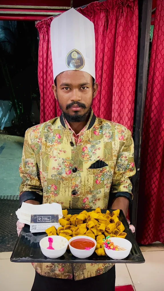 Desire Caterers uniformed staff serving fried starters at catering event in Hyderabad